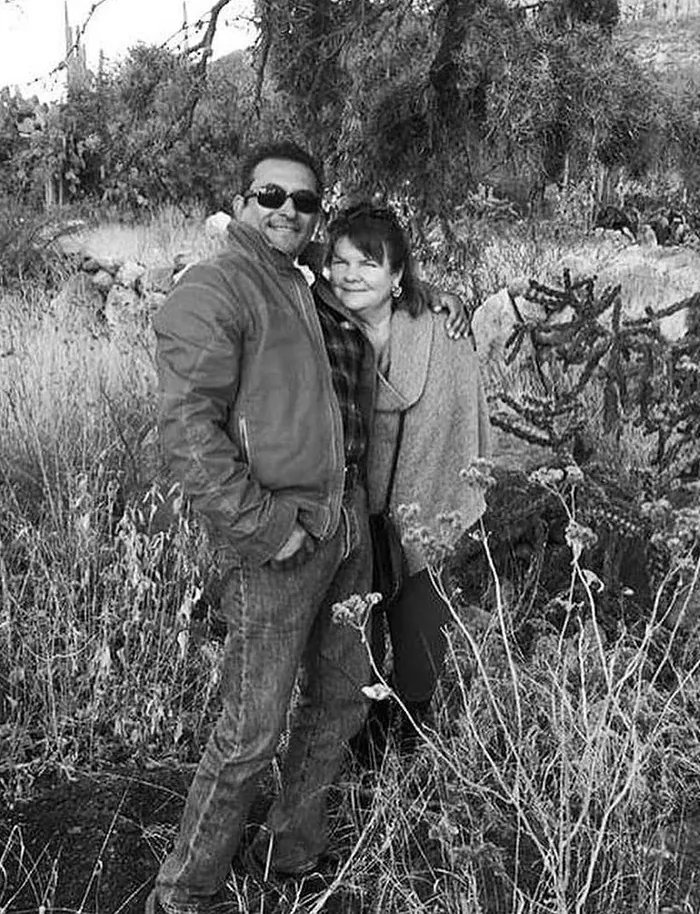 Mario and Holly Ortiz, black and white, among agave.